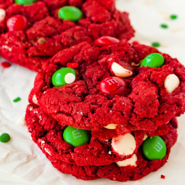 stack of red Christmas cookies with green M&Ms and white chocolate chips