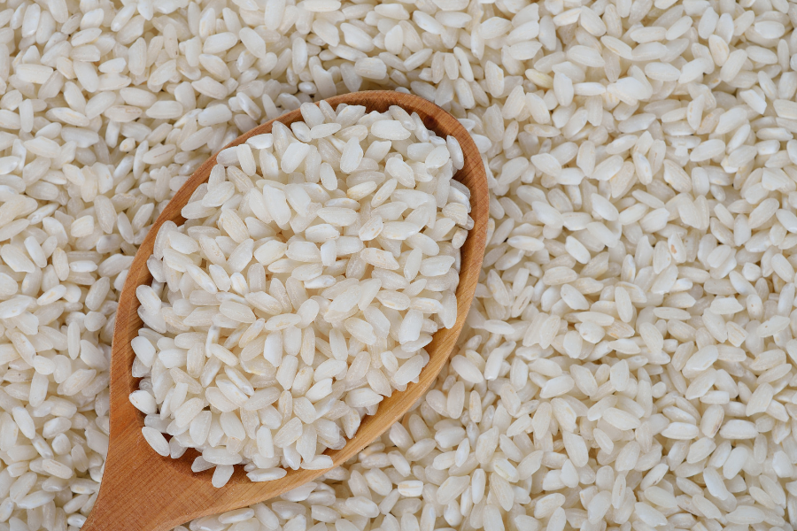 dried arborio rice with wooden spoon