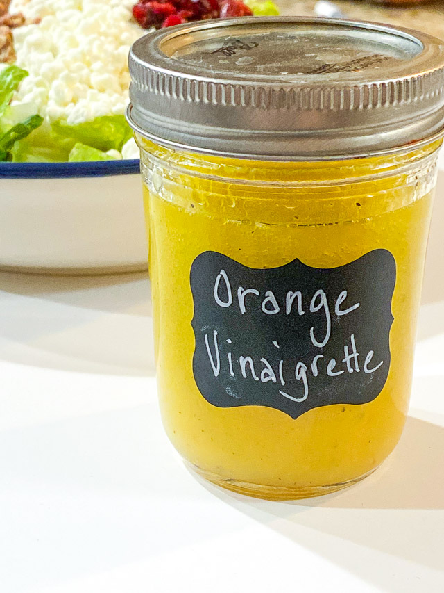 orange vinaigrette dressing in a mason jar