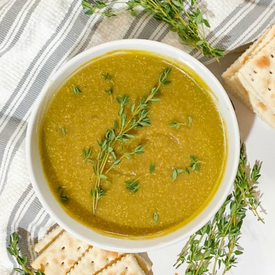 split pea soup in white bowl with thyme