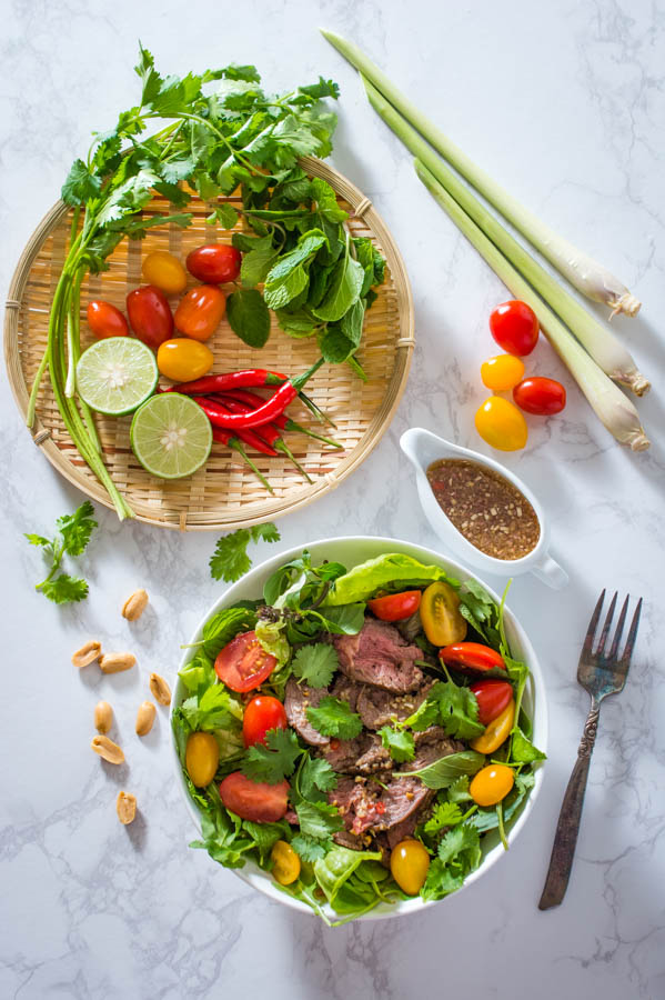 thai beef salad in a white bowl