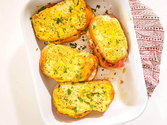 baked italian sandwiches in white dish