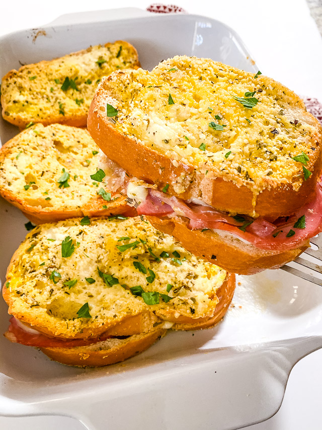 baked italian sandwiches in white dish