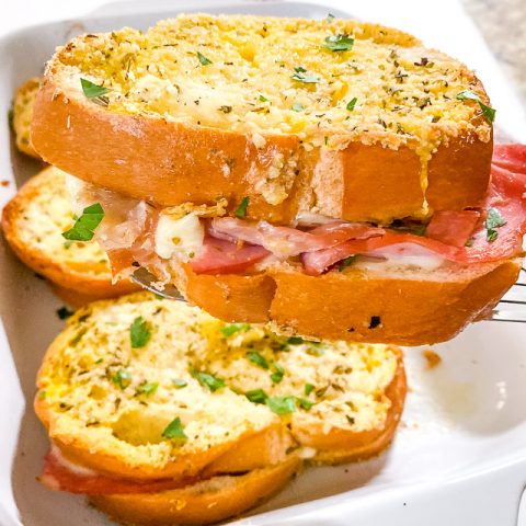 baked italian sandwiches in white dish