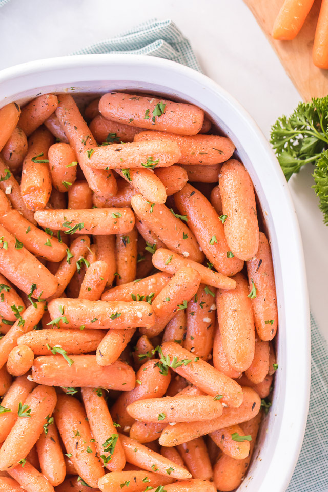 roasted baby carrots in a white pan