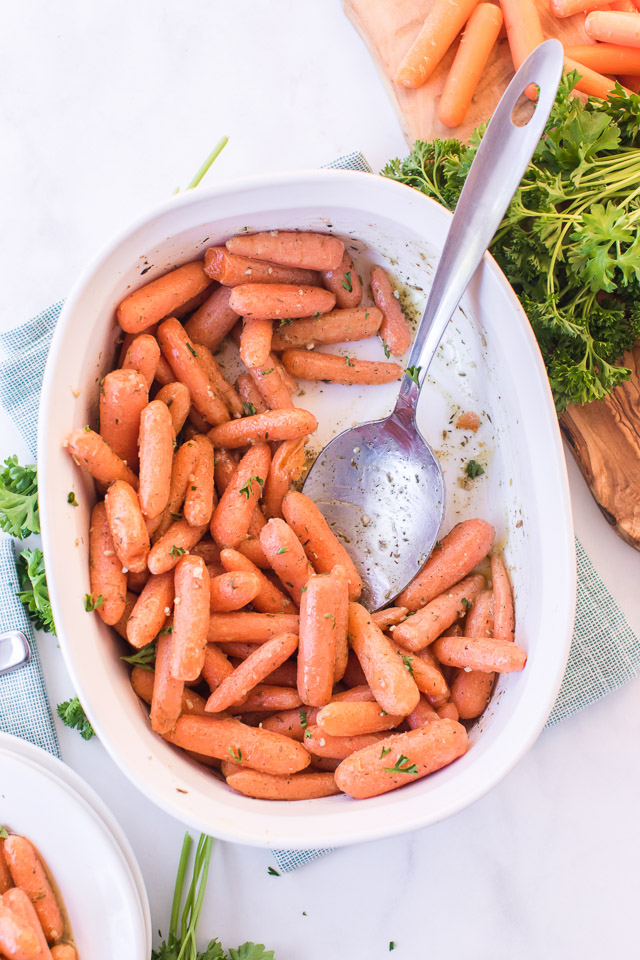 roasted baby carrots in a white pan