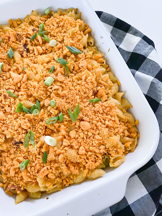 Baked Ham & Cheese Pasta Casserole in white pan with checkered napkin