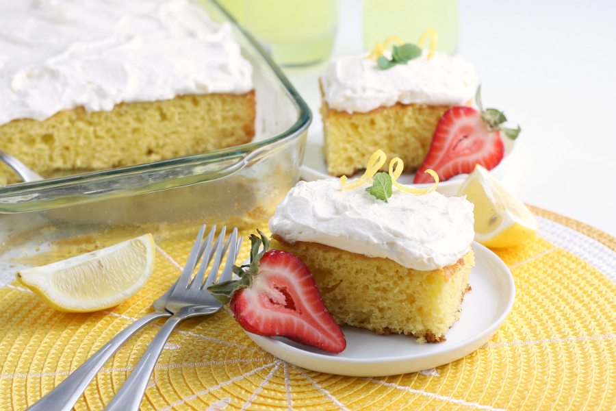 lemonade cake slices on white plates and yellow placement