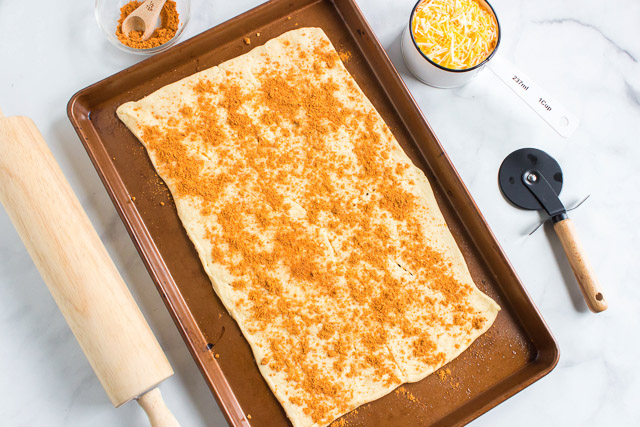 uncooked southwestern cheese breadsticks on baking sheet