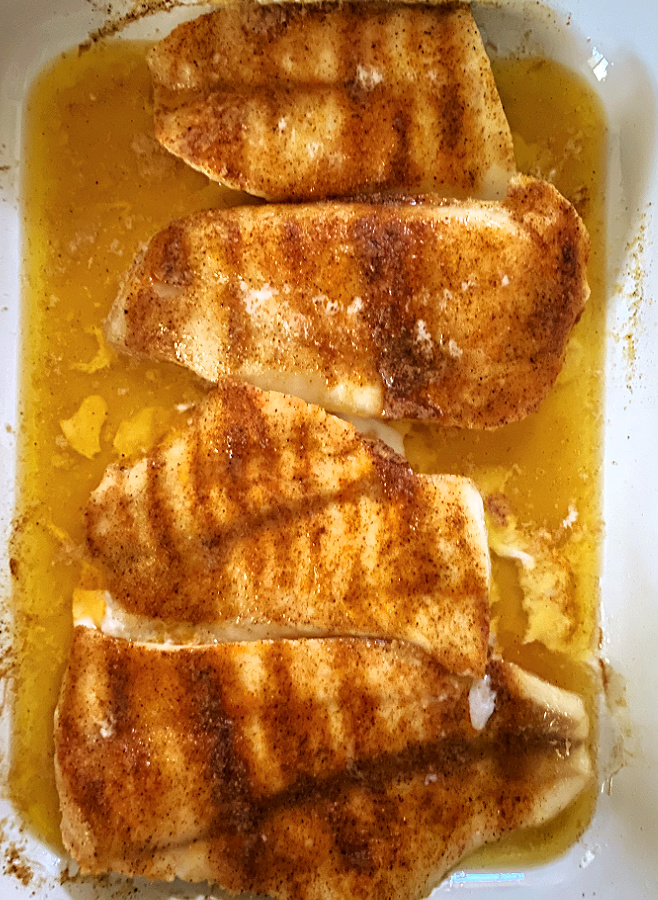cooked Cajun Oven Baked Cod in a baking dish