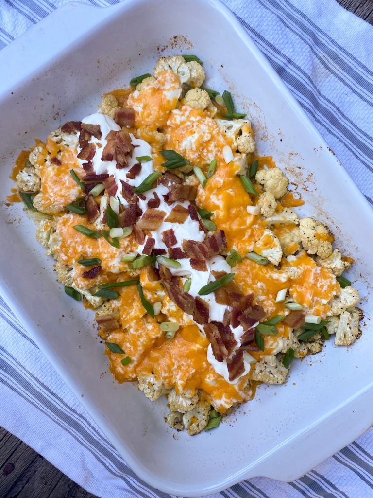 loaded keto cauliflower casserole in a baking dish