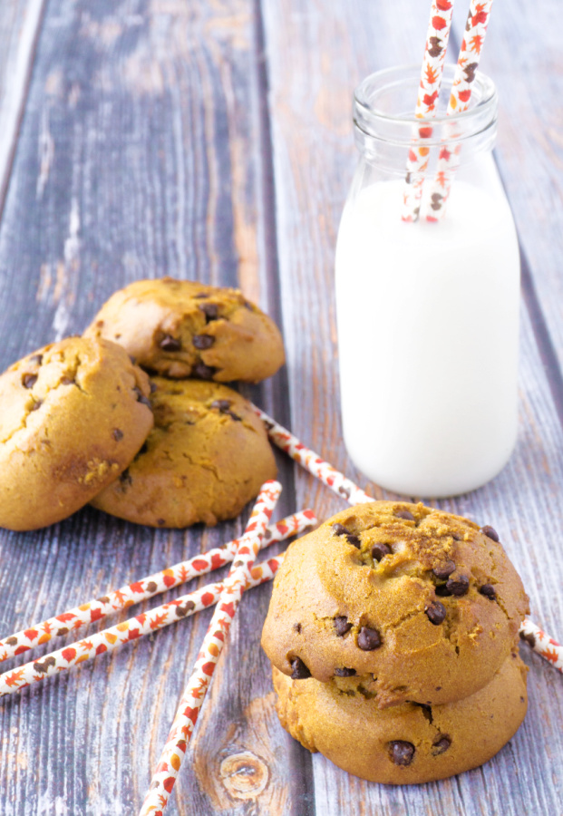 homemade pumpkin chocolate chip cookies next to glass bottle of milk