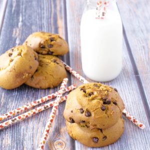 stacks of vegan chocolate chip cookies next to glass of milk