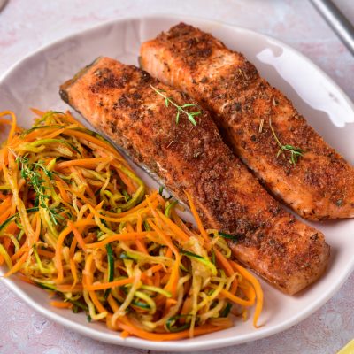 air fryer keto salmon and zoodles on white plate