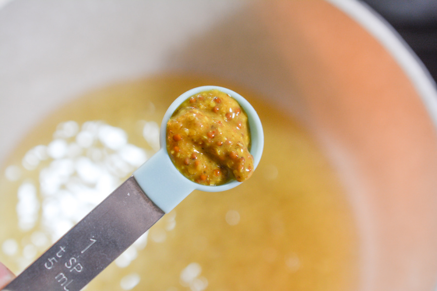 adding mustard to pot