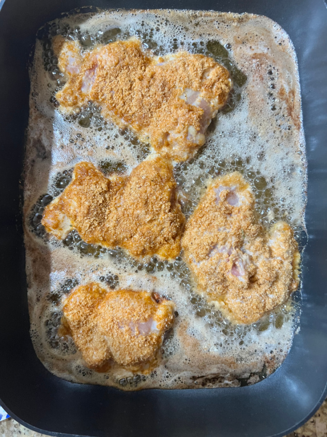 keto fried chicken cooking in pan