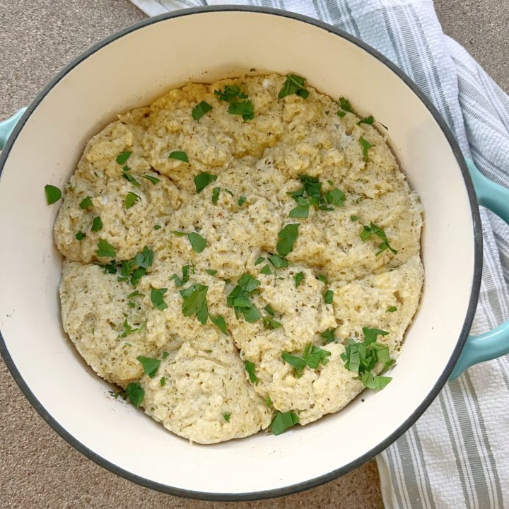 keto chicken and dumplings in a pot with a towel underneath